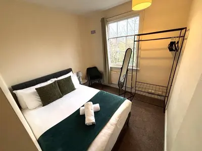 a bedroom with a bed with a towel on it at Victorian House in Cherry Orchard, Close to Town in Shrewsbury