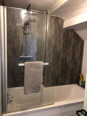 a bathroom with a shower and a tub with a towel at Cosy Pubs Bed & Breakfast in Rhayader