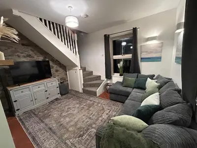 a living room with a couch and a tv at 2 bed house sleeps 4 centre of Welshpool Parking in Welshpool