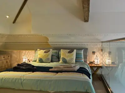 a bedroom with a large bed with pillows at Sea View in Rhyd-y-felin