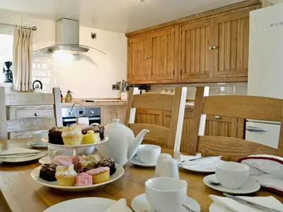 a table with three plates of cupcakes on it at Golygfar Mynydd - Mountain View in Strata Florida