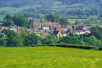 a small town on a hill with a green field at Sound of the River in Talgarth