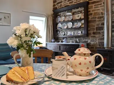 a table with a tea pot and a plate of bread at Swallow Barn in Llanwrtyd Wells