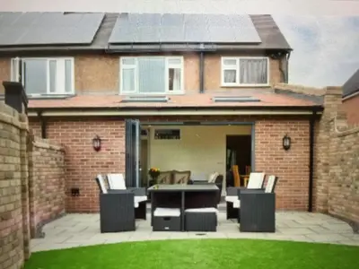 a patio with a table and chairs in front of a house at Shrewsbury Cottage in Shrewsbury