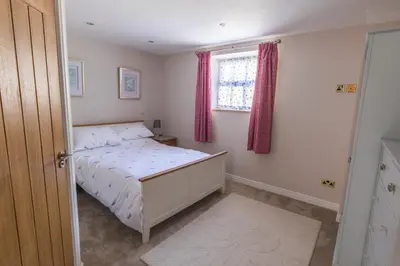 a small bedroom with a bed and a window at Gaer Fawr Barns in Guilsfield