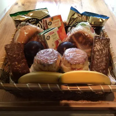 a basket filled with different types of pastries and a banana at Aberllynfi Riverside Guest House in Glasbury