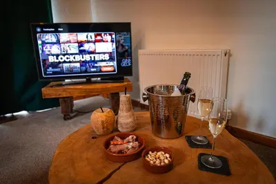 a table with wine glasses and food and a television at Irfon Cottage in Builth Wells
