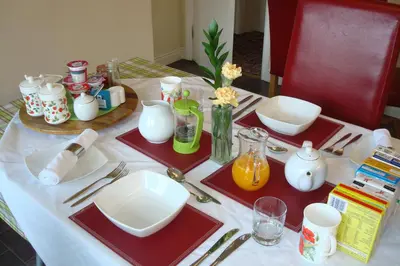 a table with plates and utensils on top at Talybont B&B Aberystwyth in Talybont