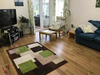 a living room with a couch and a tv at Talybont B&B Aberystwyth in Talybont