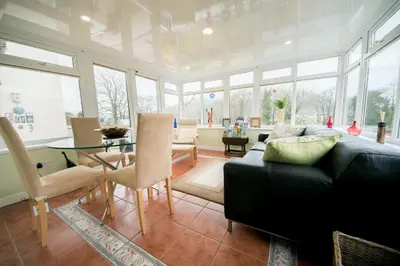 a living room with a couch and a glass table at Talybont B&B Aberystwyth in Talybont