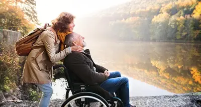 a woman standing next to a man in a wheelchair at Mid Wales Holiday Lets, Rhayader in Rhayader