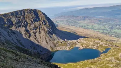 an aerial view of a mountain with a lake at Dinas in Llanbedr