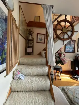 a set of three stairs in a room with at Parrs cottage in Wollaston