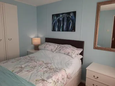 a bedroom with a bed and a mirror at Cerdyn Villa in Llanwrtyd Wells