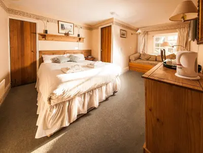 a bedroom with a large white bed in a room at Gales Of Llangollen in Llangollen