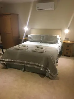 a bedroom with a bed with two towels on it at Bryn Derwen in Rhayader