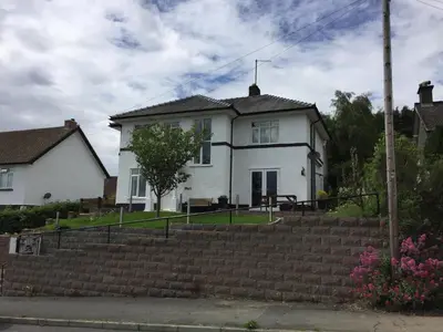 a white house with stairs in front of it at Bryn Derwen in Rhayader