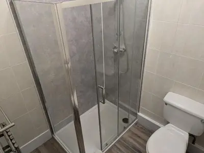 a shower stall in a bathroom with a toilet at Llangollen Hostel - Book Whole Room - Self Catering Facilities in Llangollen