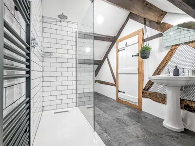a bathroom with a sink and a glass shower at Ty'n Y Ffordd in Llanymawddwy