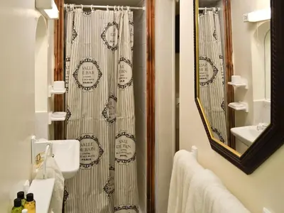a bathroom with a shower curtain and a sink at Y Bwthyn in Bala