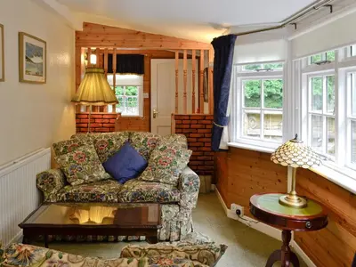 a living room with a couch and a table at Y Bwthyn in Bala