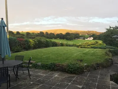 a view of a garden with a table and chairs at The Old Post Office in Myddfai