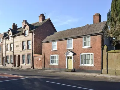 a row of brick houses on a street at Friary Cottage in Ludlow
