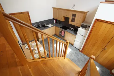 an overhead view of a kitchen with a staircase at Beudy Taicroesion in Barmouth