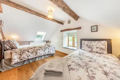 a bedroom with two beds and a window at 2 Bed in Bala oc-82768 in Llandderfel