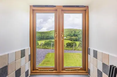 a window with a view of a green field at 2 Bed in Bala oc-82768 in Llandderfel