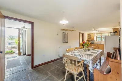 a kitchen and dining room with a table and chairs at 4 Bed in Builth Wells oc-39461 in Builth Wells
