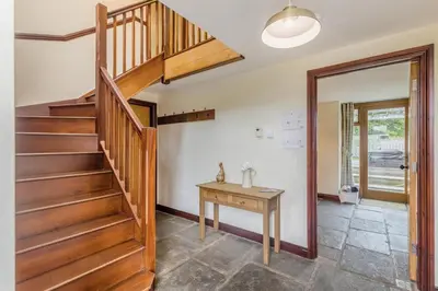 a wooden staircase in a room with a table at 4 Bed in Builth Wells oc-39461 in Builth Wells