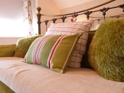 a group of pillows sitting on a bed at Drws y Nant in Dolgellau