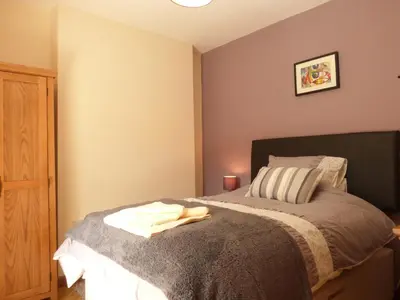 a bedroom with a bed with a towel on it at Gwarcwm Uchaf in Tre-Taliesin