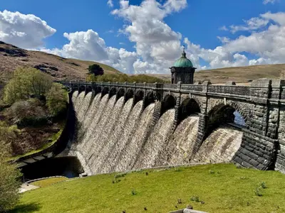a dam on a river with a building in the background at 4 Bed in Builth Wells oc-39473 in Builth Wells