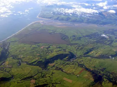 an aerial view of a field and a river at Llety'r Buarth in Talybont