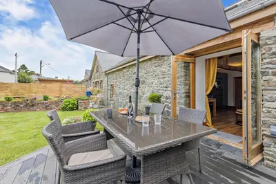 a table and chairs with an umbrella on a patio at 2 Bed in Bala oc-82212 in Bala