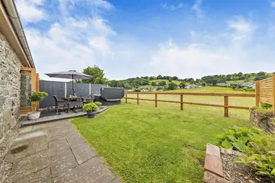 a backyard with a table and an umbrella at 2 Bed in Bala oc-82212 in Bala
