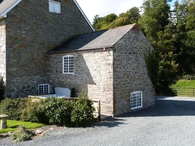 a brick building with white windows on the side of it at Tref y Nant in Castle Caereinion