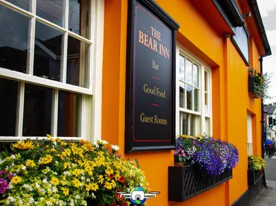 a building with flowers on the side of it at The Bear Inn in Llandovery