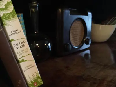 a microwave sitting on a counter next to a book at Half Moon House in Hay-on-Wye
