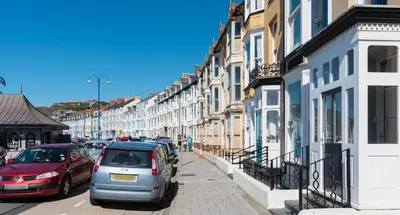a street with cars parked on the street at Sea view Ar Lan y Mor LUXURY APARTMENT in Aberystwyth