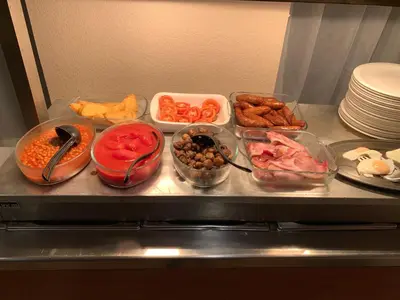 a refrigerator filled with different types of food in bowls at Four Seasons Budget in Aberystwyth
