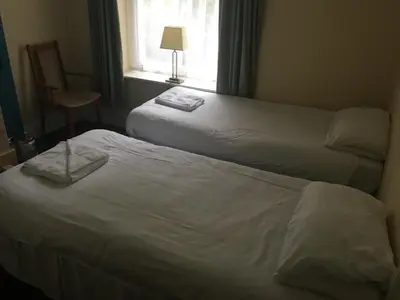 a hotel room with two beds and a window at Four Seasons Budget in Aberystwyth