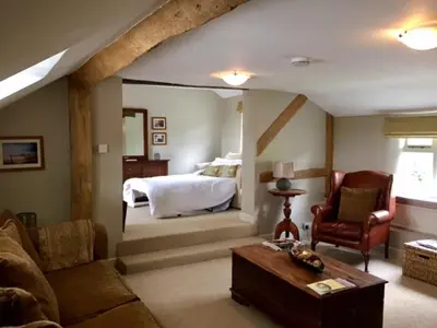 a living room with a bed and a couch at The Old Three Pigeons in Nesscliffe