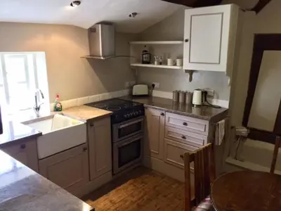 a kitchen with a sink and a stove top oven at The Old Three Pigeons in Nesscliffe