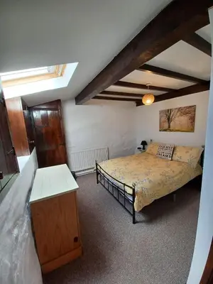 a bedroom with a large bed in a room at Ty Mawr at Bethania B&B Rooms and Crumble Cottage in Llanon