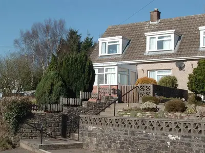 a house with a fence and stairs in front of it at Cosy Twin Room in Brecon in Brecon