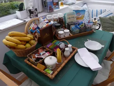 a table with a basket of food and bananas on it at Cosy Twin Room in Brecon in Brecon