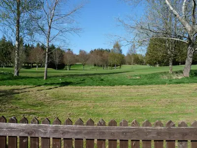 a park with a fence and a field with trees at Cosy Twin Room in Brecon in Brecon